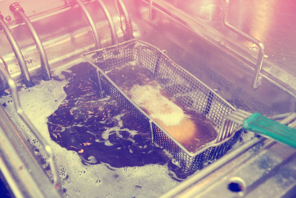 deep frying oil in a commercial metal fryer in a restaurant