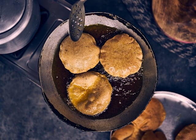 an image of some puri being fried