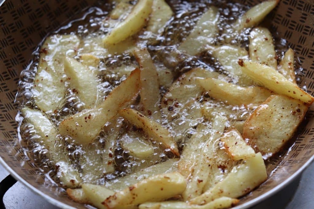 an image of some chips or fries cooking in oil
