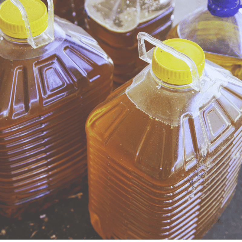 Waste cooking oil properly stored in sealed containers ready for collection